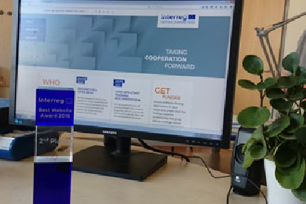 Trophy in front of computer screen Trophy in front of computer screen